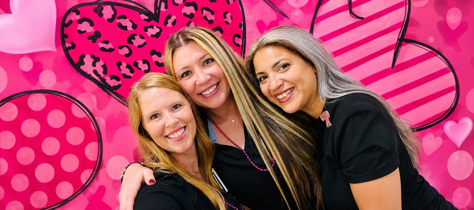 three team members smiling for the camera